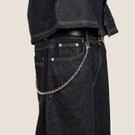 ICED London dark denim jeans with a silver chain attached to the belt loop; side view of rugged indigo denim.