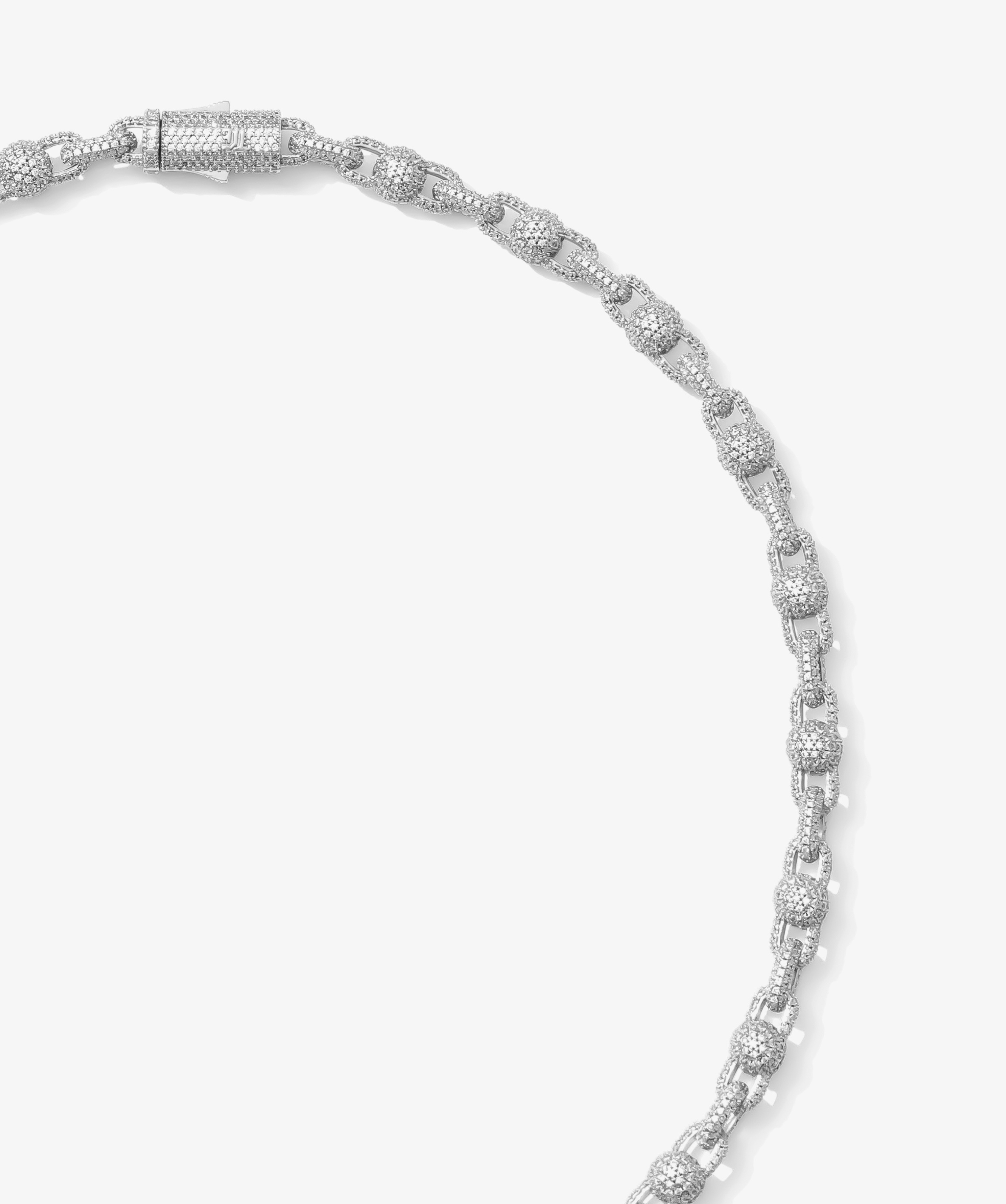 ICED London diamond tennis bracelet in white gold with pavé-set diamonds, close-up shot of linked, sparkling segments.