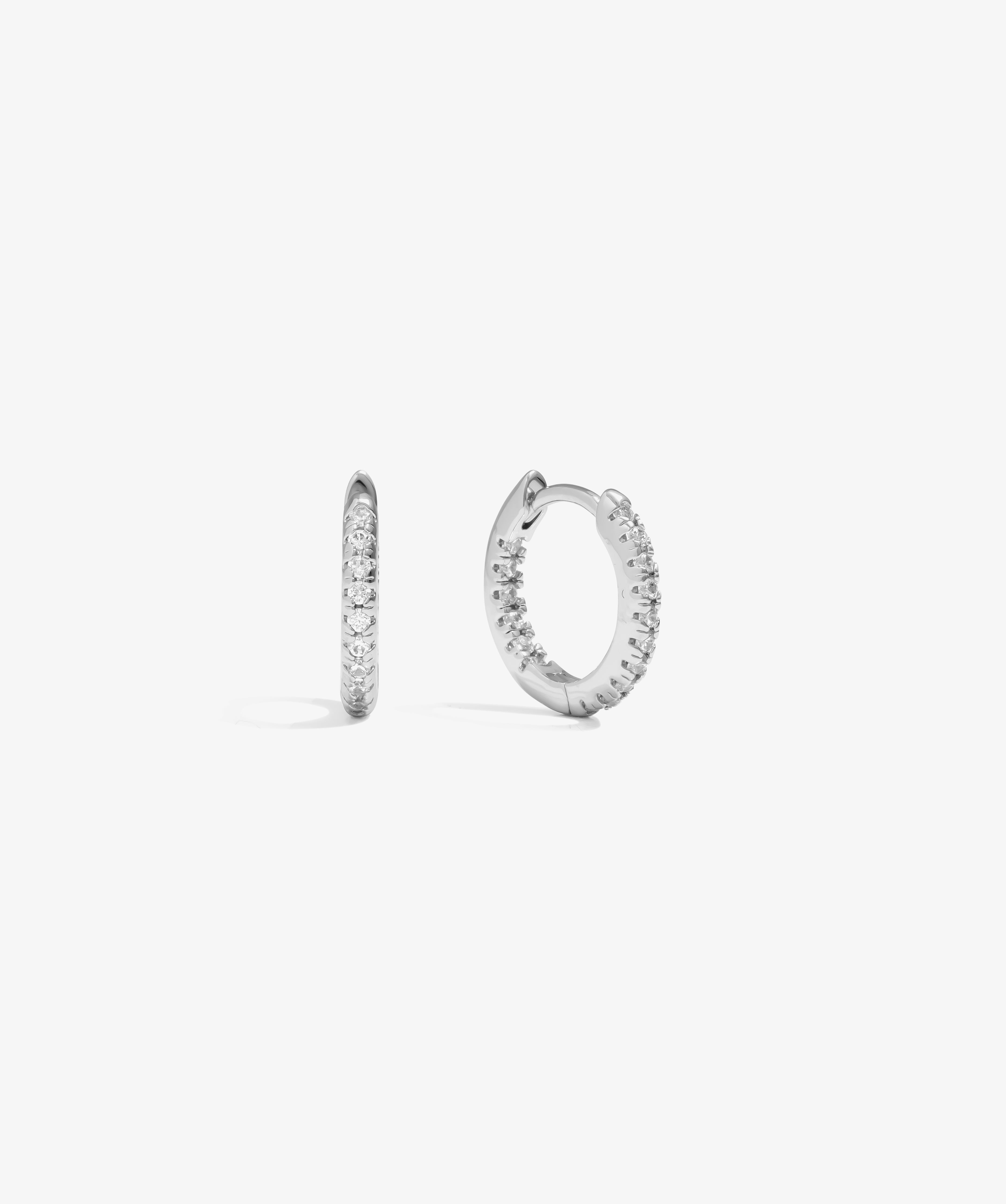 ICED London silver hoop earrings with pavé crystals along the outer edge, shown from front and side.