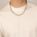 ICED London silver chain necklace worn by a man in a white crew-neck tee; close-up.