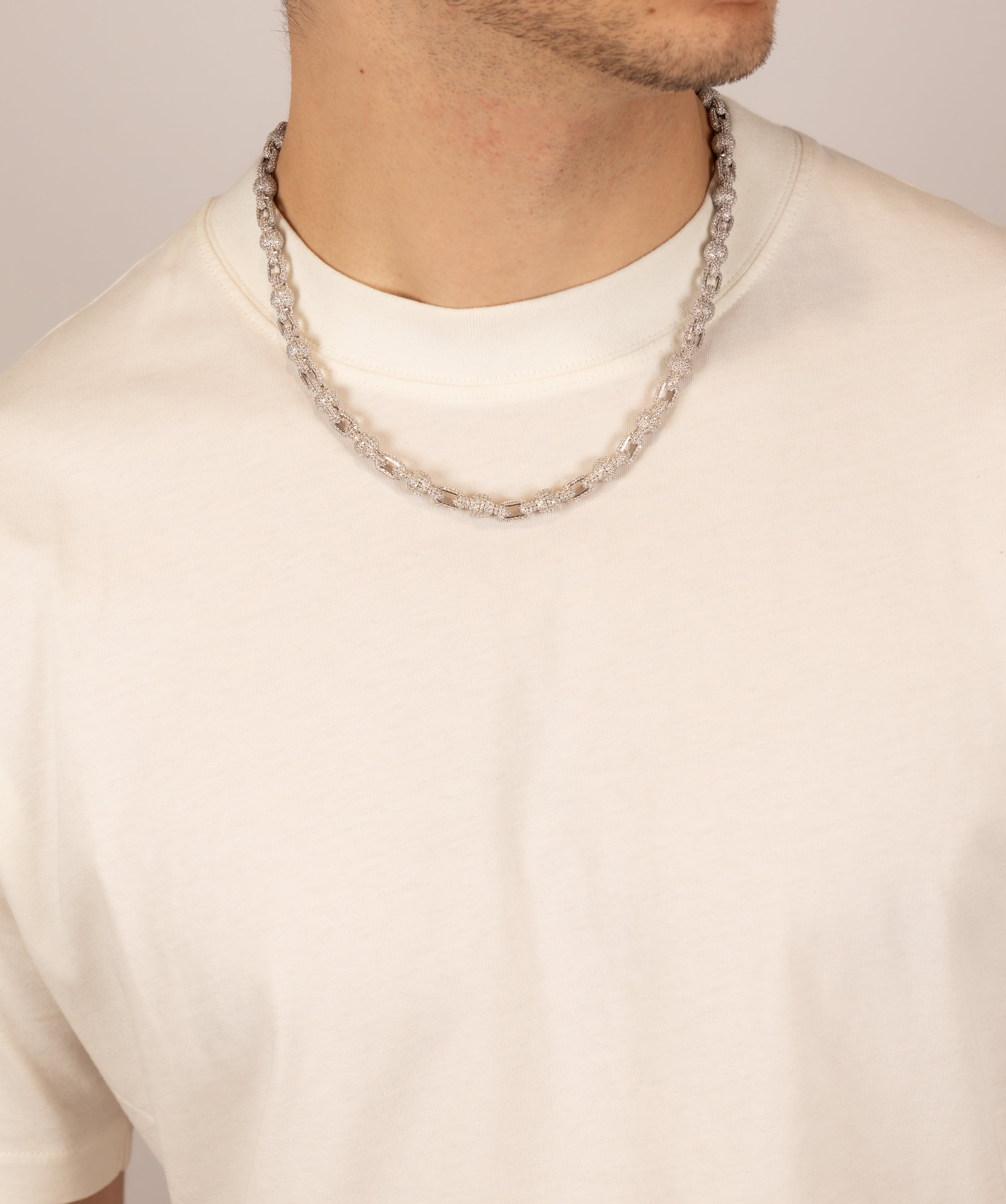 ICED London silver chain necklace worn by a man in a white crew-neck tee; close-up.