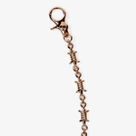 ICED London rose-gold keychain with barbed-wire style links and lobster clasp, close-up.