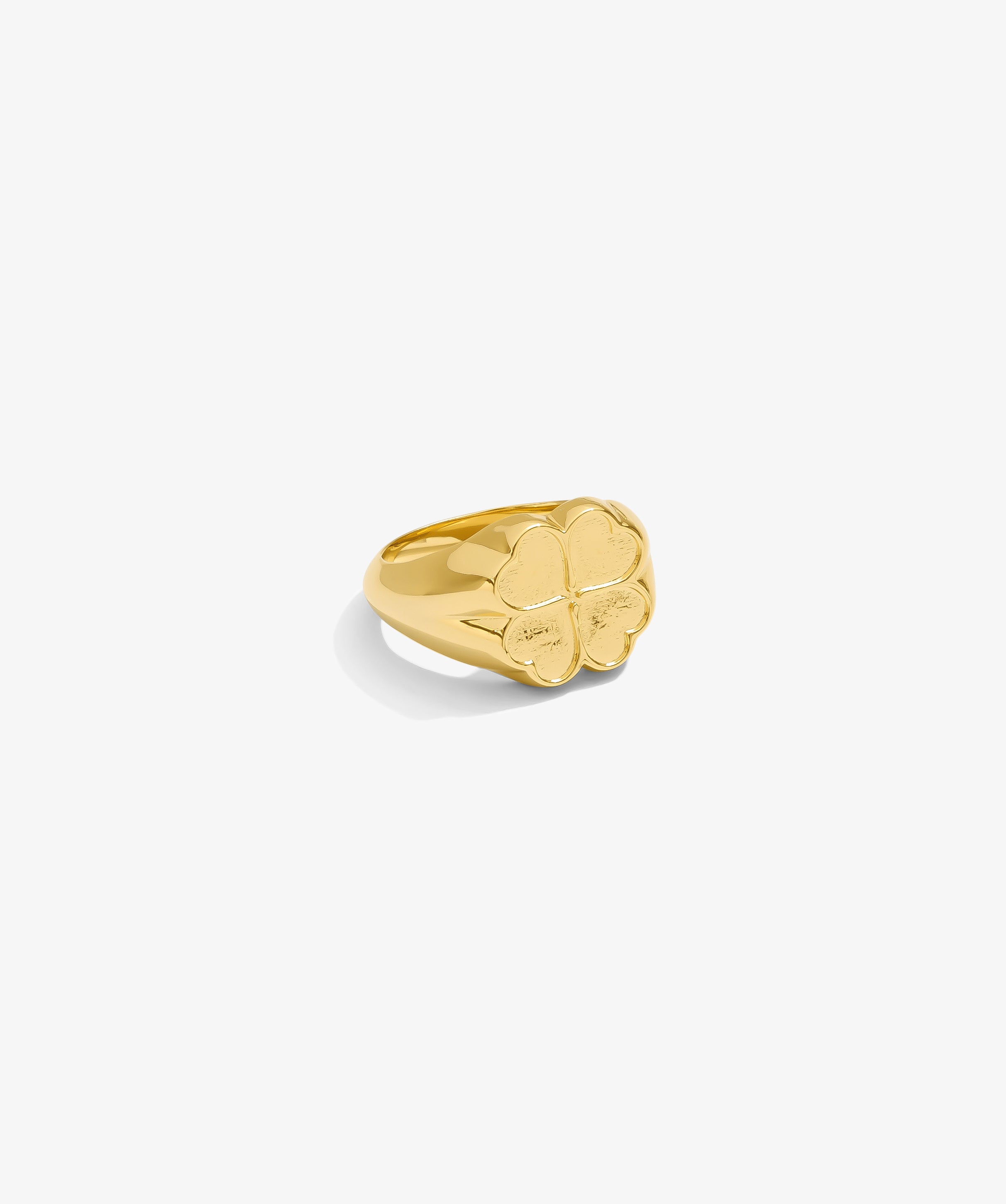 ICED London gold ring with a four-leaf clover motif on a smooth, polished band.