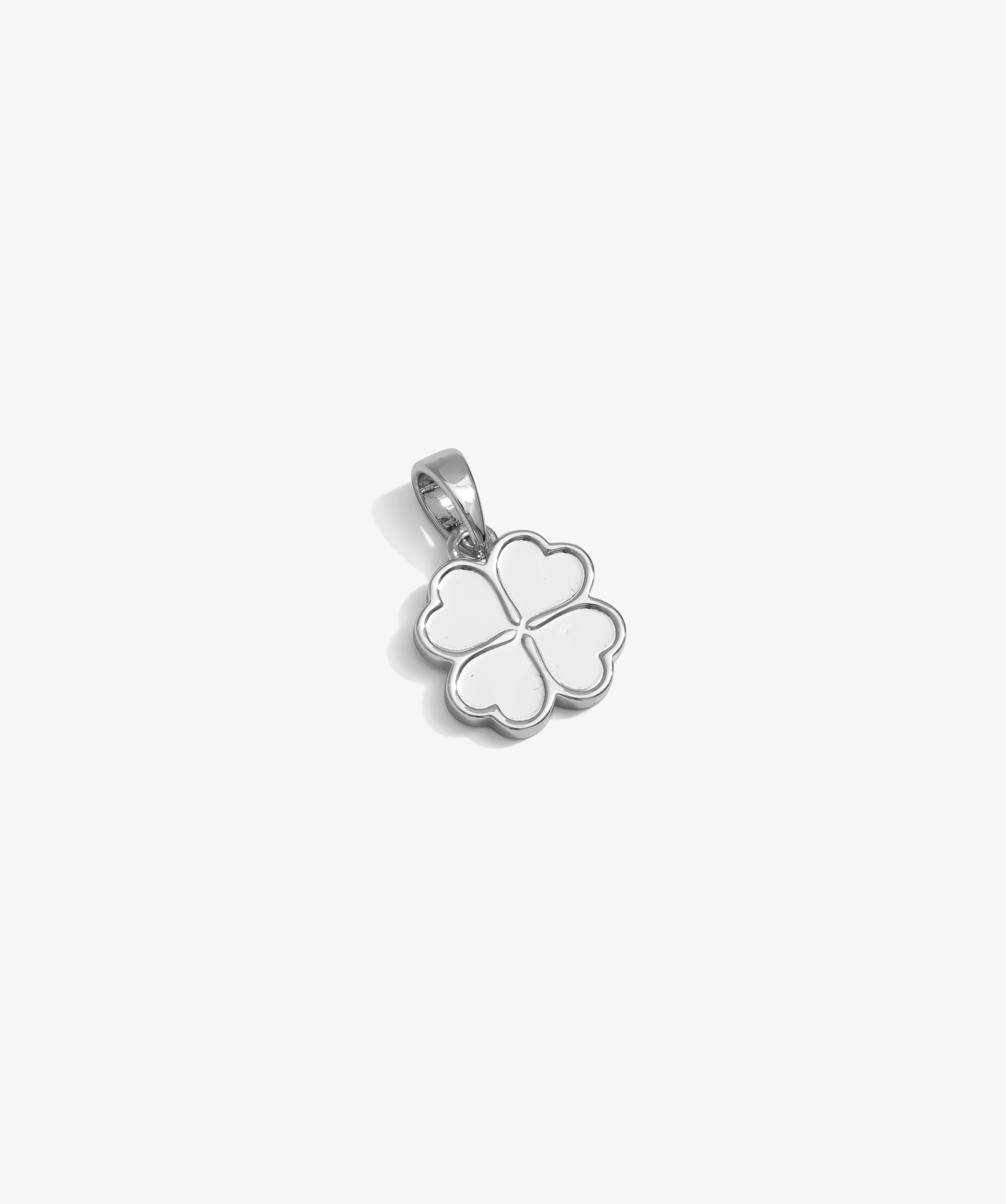 ICED London silver four-leaf clover pendant with outlined petals, bail attachment, minimalist jewelry charm.