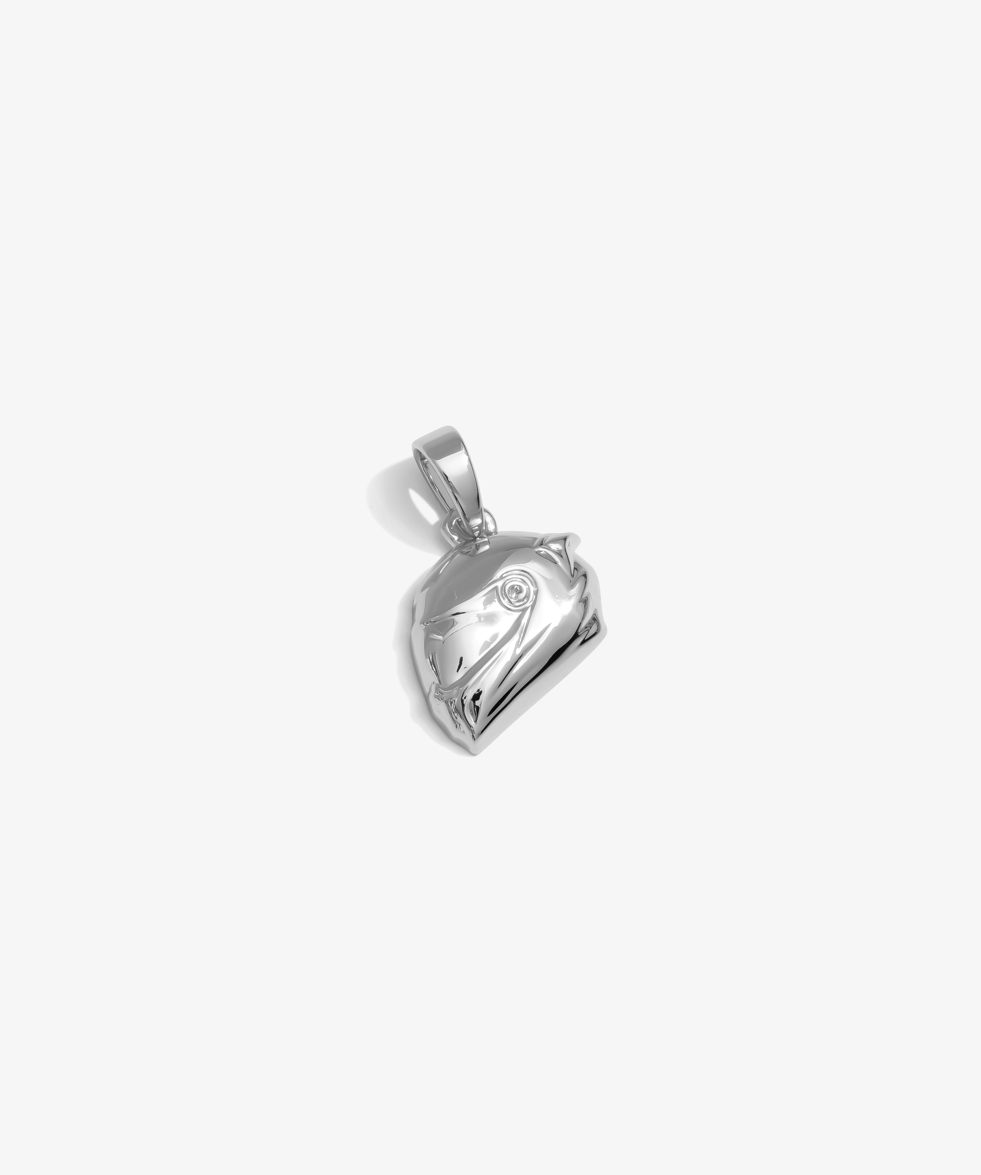 ICED London silver heart pendant, polished metal with subtle swirl, close-up on the bail.