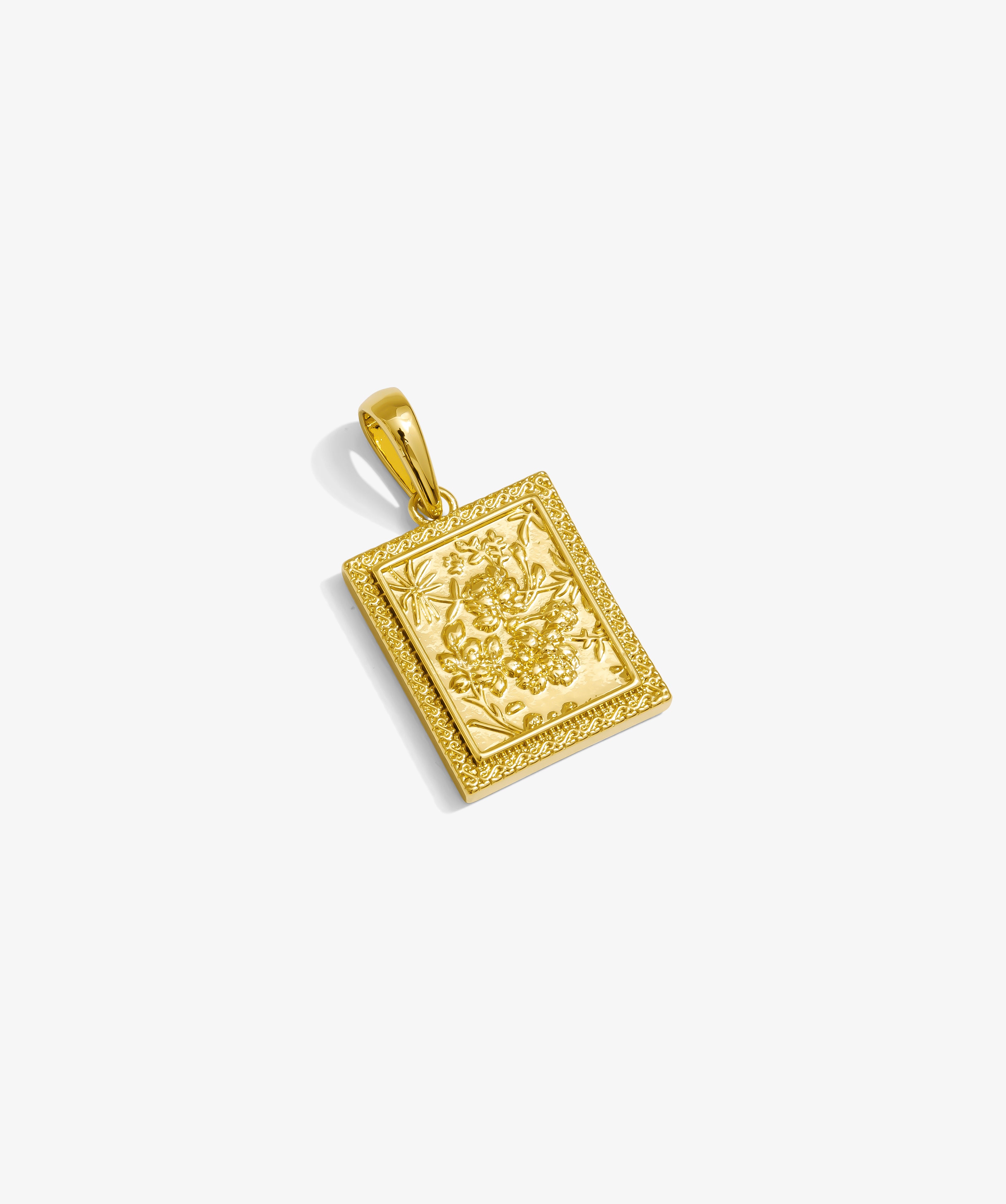 ICED London gold rectangular pendant with floral engraving and ornate border.