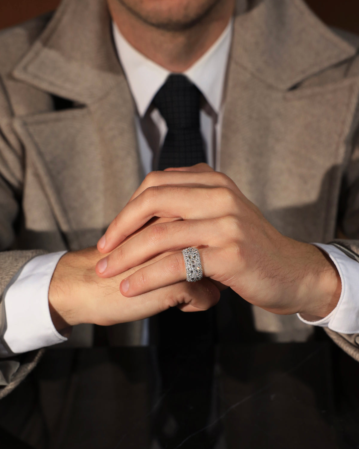 The Inverted Diamond Band worn on the little finger with tailored outerwear