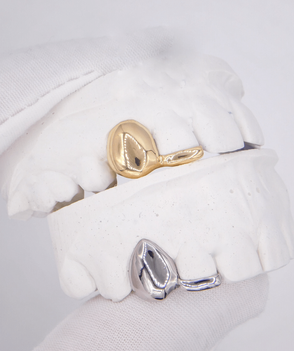 ICED London: gold and silver signet rings displayed on a dental plaster model for product photography.