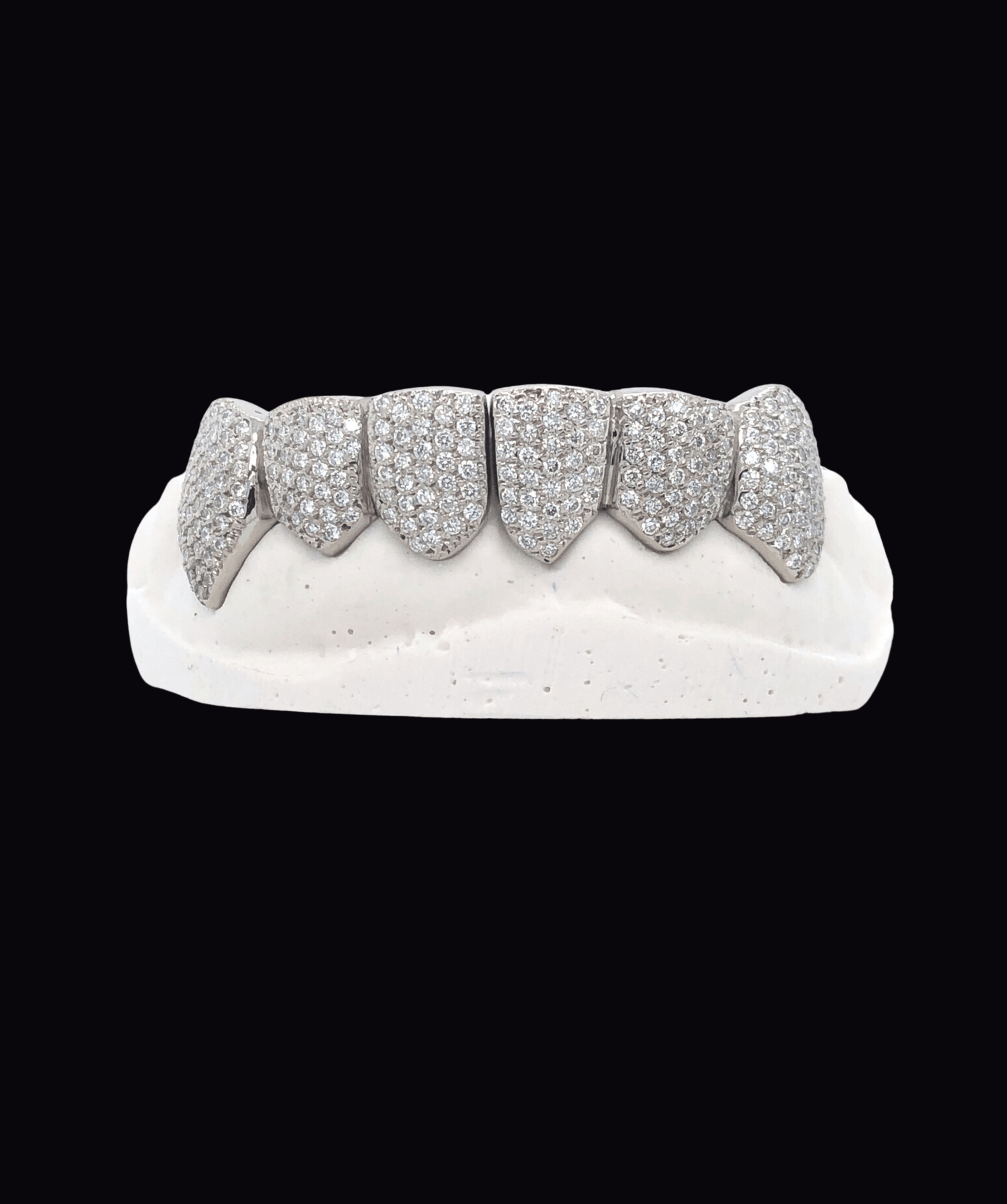 ICED London diamond grillz on a white dental mold; pavé-set tooth jewelry.