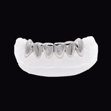 ICED London silver dental grillz on a white dental cast arch, front view.